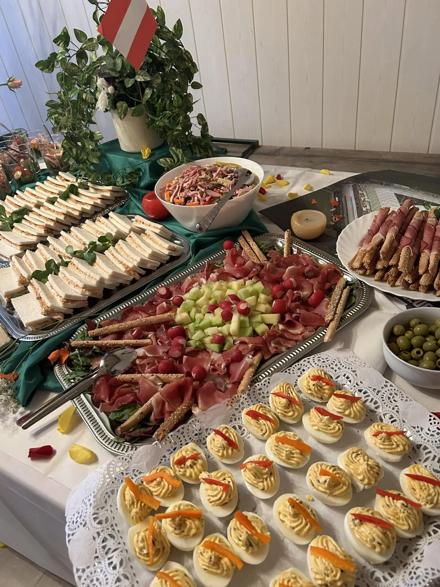 Cold catering buffet with sandwiches and antipasti